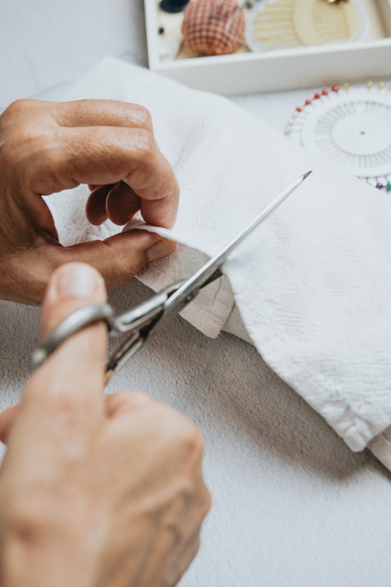 Artisan at work embroidering fine fabric in studio